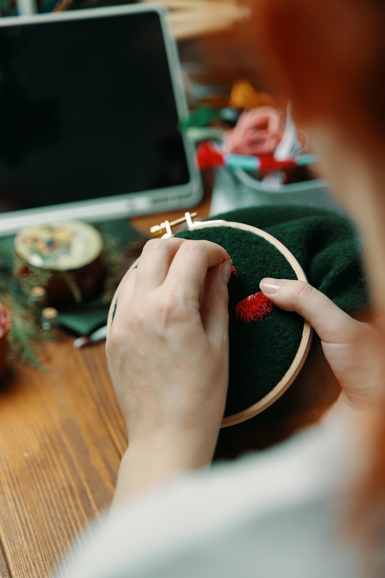 Instructor demonstrating hand embroidery techniques