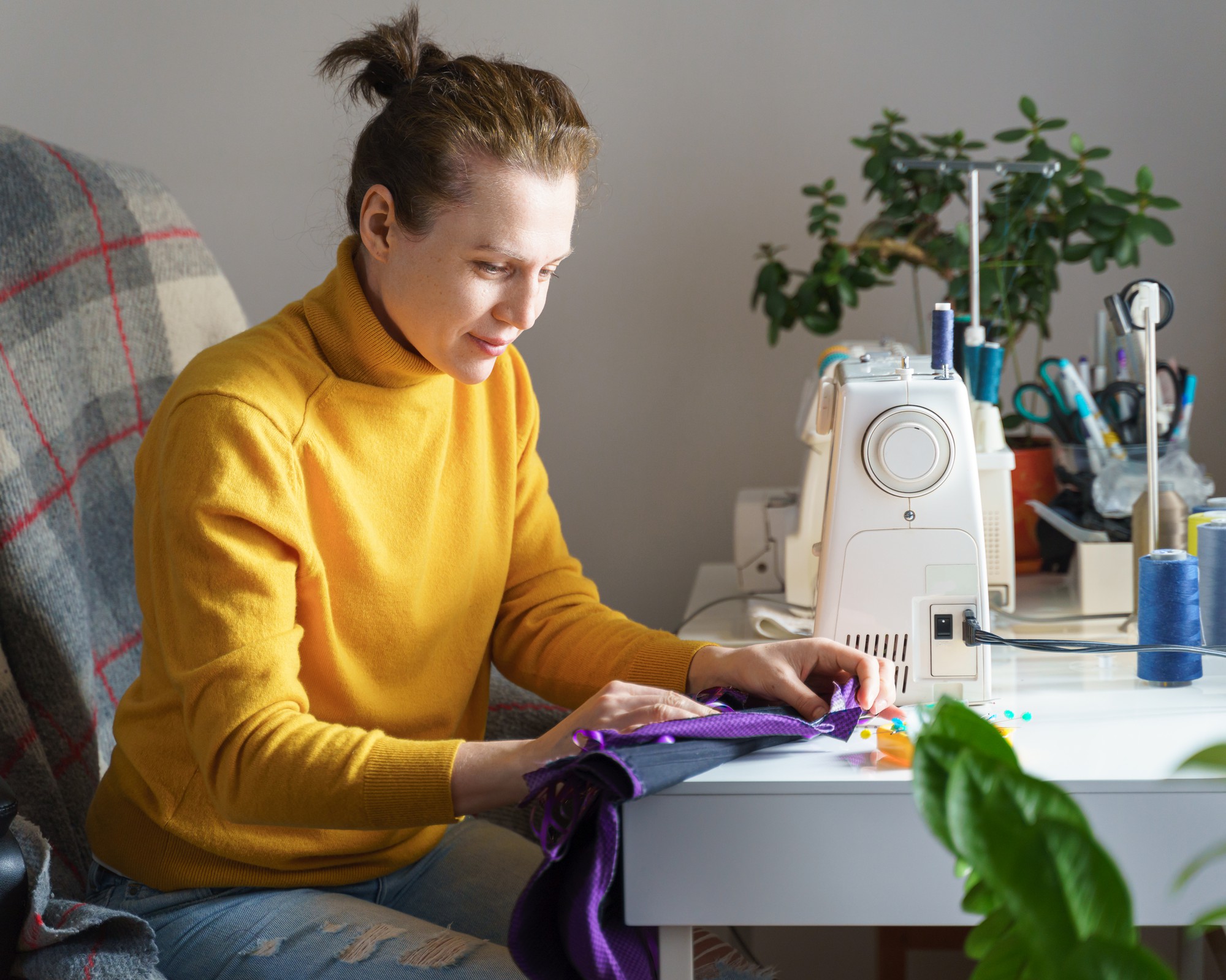 Student stitching a pattern at home